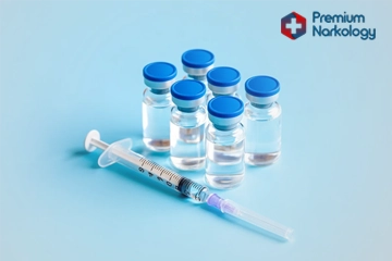 Шприц с медикаментом  и пузырьки с лекарством